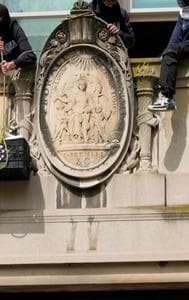 A student protester pulls up a crate filled with foot and supplies from a balcony of Hamilton Hall on the campus of Columbia University, Tuesday, April 30, 2024, in New York.