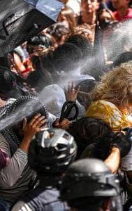 Police pepper spray pro-Palestinian protesters blocking police vehicles from leaving the University of Texas in Austin, Texas, Monday, April 29, 2024. 